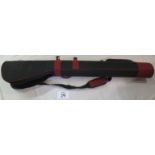 A black canvas rigid double shotgun sleeve with handles and should strap.