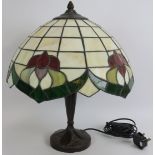 A contemporary Tiffany style table lamp with stained glass shade and bronzed base. Height: 45cm,