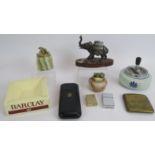 An unusual elephant shaped table lighter, two onyx table lighters, two vintage lighters, a cigarette