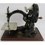 A Willcox and Gibbs chain stitch sewing machine with carry case and manual. Circa 1900. Condition