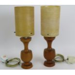 A pair of mid century Danish style teak lamps with period spun fibreglass shades. Overall height: