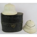 Two English white pith helmets, both with leather liners, one with strap, and a large copper