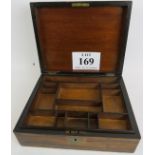 A Victorian figured walnut work box with brass escutcheons, the hinged lid enclosing a fitted tray