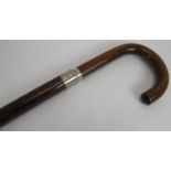 A vintage umbrella walking stick with four section collapsible shaft and black silk canopy.