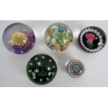 Five glass paperweights including one signed Selkirk glass weight, another signed CIIG and one