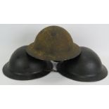 Three WW2 period British helmets all with liners. One steel dated 1939 and two black composite. (3).