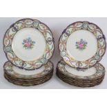 A set of 12 French porcelain Chateau Des Tuileries plates with hand painted floral decoration and