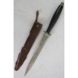 A vintage Mexican stiletto dagger in tooled leather sheath. The blade being etched on both sides.