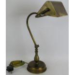 A vintage 1930's style patinated brass banker's lamp with adjustable stand and shade, refurbished.