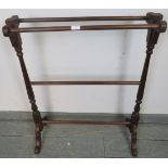 An Edwardian mahogany double towel rail, on scrolled supports. Condition report: No issues. H89cm