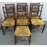 Seven assorted Lancashire spindle back dining chairs, with rush seats, on tapering supports with