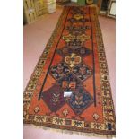 A fine South West Persian Qashqai runner, central pattern on a burnt amber field and in very good