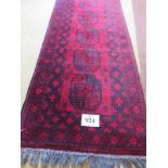 A mid 20th century Persian runner, 8 central repeat motifs on burgundy ground, 290cm x 77cm. Good