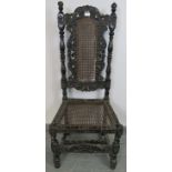 A 19th century Carolean style oak hall chair, ornately carved with acanthus leaves and roundels,