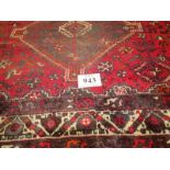 A mid 20th century Persian carpet. 3 repeat central motifs with stylised birds on a claret field.