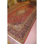 An excellent central Persian Kashan carpet, central pattern rising from cream to blue to red. In