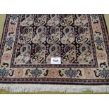 A late 20th century wool rug with a repeat pattern to central field, blue/cream. 200cm x 121cm. Very