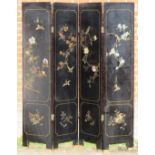 An antique Chinese lacquered four section folding screen, featuring mother of pearl inlay with