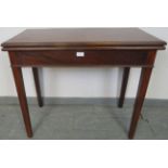 A turn of the century mahogany turnover tea table with single blind drawer, on square supports.