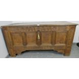 A large 17th century medium oak panelled coffer, the front featuring chisel carved frieze with