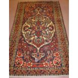 Central Persian Bakhtiar rug, with central motif on green ground and deep terracotta borders