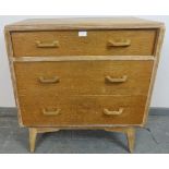 A mid-century light oak chest of three graduated drawers, part of the Brandon range by G-Plan, on