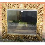 A 19th century Florentine style bevelled rectangular wall mirror, the ornate carved and pierced