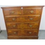 An Edwardian burr walnut chest of two short over three long drawers, fitted with fancy brass