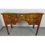 A George III serpentine fronted mahogany and satinwood sideboard, crossbanded and strung