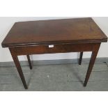 A Georgian mahogany turnover tea table, with ebony and satinwood inlay and single blind drawer, on