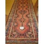 A good early/mid 20th century Persian runner (poss Shiraz). Central motifs on pink ground flanked by
