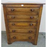 A vintage period style oak chest of five graduated drawers, with turned handles, on bracket feet.