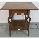 An Arts & Crafts medium oak two-tier occasional table, with arcaded frieze and pierced, shaped