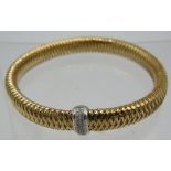 A Roberto Coin 18ct Italian gold flexible bracelet with a white gold collar set with 26 brilliant