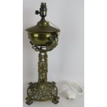 An Art Nouveau cast brass oil lamp with ivy and berry patterned base later converted to electricity.