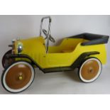 A vintage style child's pedal car of steel construction with working steering. Length 96cm.