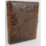 A leather bound Victorian photo album with Art Nouveau decorated binding, gilt edges pages and