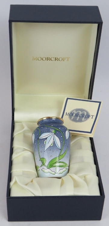 A miniature Moorcroft enamel vase with snowdrop decoration in presentation case. Height 7cm.