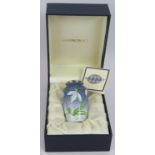 A miniature Moorcroft enamel vase with snowdrop decoration in presentation case. Height 7cm.