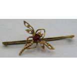 A 9ct yellow gold fine model of a dragonfly brooch, the body set with garnet. Approx weight 3.5