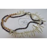 An unusual pearl stick & coral necklace and a black pearl necklace interspersed with yellow metal