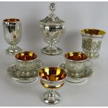Six pieces of antique continental mercury glass including two cups and saucers, three goblets and