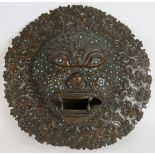 An antique bronze Indian temple mask inset with small blue stones. Believed to be used for warding
