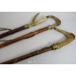 Three hand crafted walking staffs, each with antler handles and decorated with Scottish metal