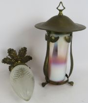An early 20th century Arts & Crafts style brass lantern with graduated milk glass shade and