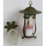 An early 20th century Arts & Crafts style brass lantern with graduated milk glass shade and