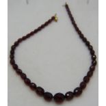 A graduated cherry amber vintage necklace. Re-strung and with 9ct yellow gold clasp. Largest bead