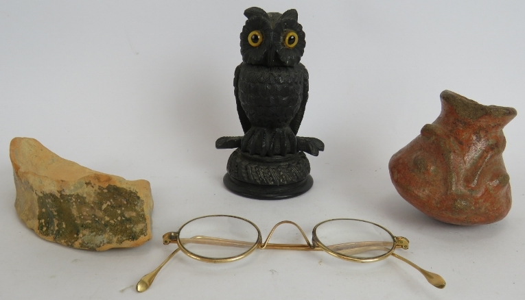 An antique Irish bog oak table vesta match holder in the form of an owl with glass eyes, a pair of