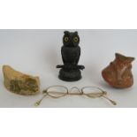 An antique Irish bog oak table vesta match holder in the form of an owl with glass eyes, a pair of