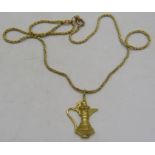 An Omani 18ct yellow gold coffee pot pendant on a 14ct yellow gold chain. Condition report: Good